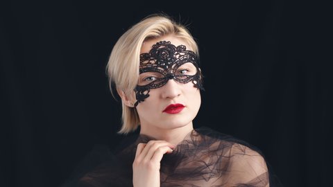 Elegant Mature Woman Wearing Black Lace Mask. Isolated on black