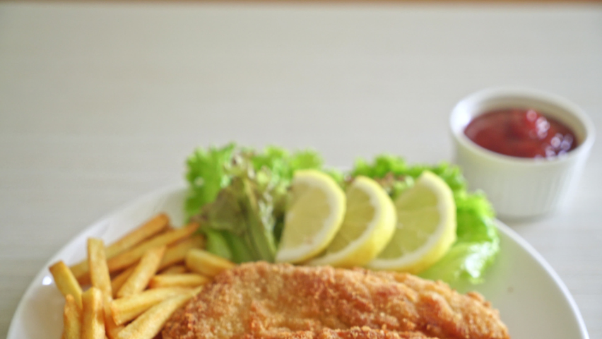 Homemade Breaded Weiner Schnitzel with Potato Chips - Fried Chicken with french fries - European food style Royalty-Free Stock Footage #1087976815