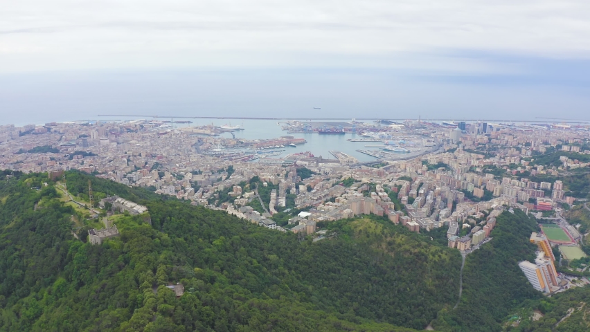 Inscription on video. Genoa, Italy. Central part of the city, aerial view. Ships in the port. Text furry, Aerial View