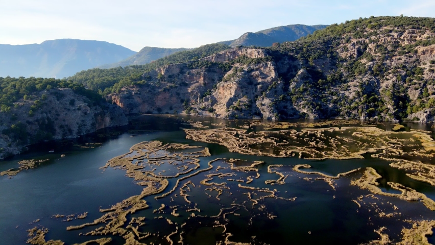 A shining summer sun and people sunbathing on the beach while enjoying the boat at Muğla Iztuzu Beach, one of Turkey