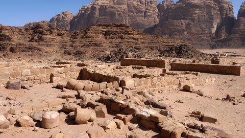 Ruins of ancient houses of the Nabataeans in the Wadi Rum desert or Valley of the Moon in Jordan. Uadi rum is a valley cut into the sandstone and granite rock close to Aqaba
