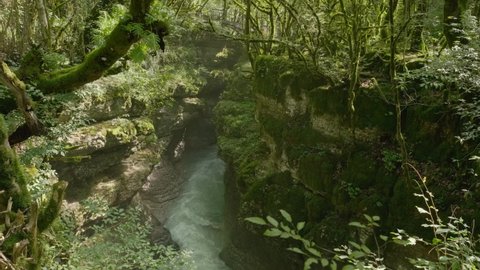 Martvili canyon in Georgia. Beautiful nature scene with deep green canyon and waterfall with a rainbow. Beautiful natural kanyon near Kutaisi city. Nature landscape. Slow tilt footage