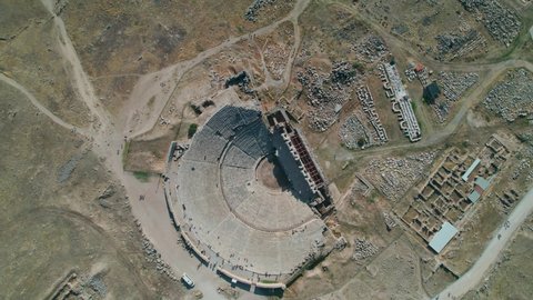 4K colour graded aerial footage of Hierapolis Ancient Theatre in Pamukkale, Denizli,  Turkey on a sunny day. Top down bird's eye view of the Turkish architecture relics