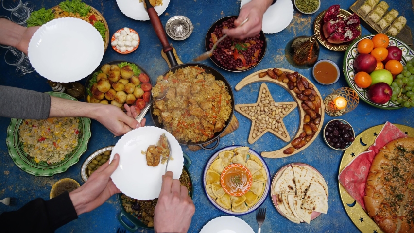 Ramadan kareem. Iftar dinner table top view. Happy authentic arabic muslim family have a dinner in kitchen together. Concept of religion, lifestyle, social, family. Slow Motion Royalty-Free Stock Footage #1087986935