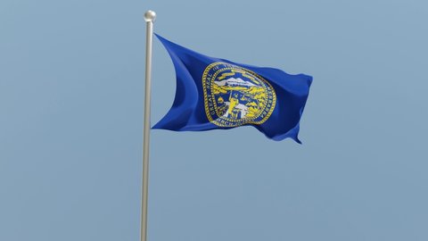 Nebraska flag on flagpole. NE flag fluttering in the wind. USA.