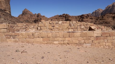 Wadi Rum Jordan ruins of stone buildings in the desert Valley of the Moon. High quality 4k video shot with gimbal in motion to give dynamism to an archaeological site.