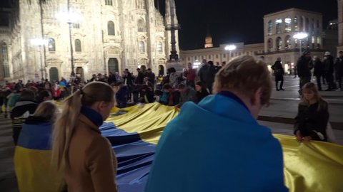 Ukrainian women and girls protest at Piazza Duomo Milano against the war and against Russian leader Putin. war in Ukraine. people with placards, flags Europe, Italy Milan, march 2022 