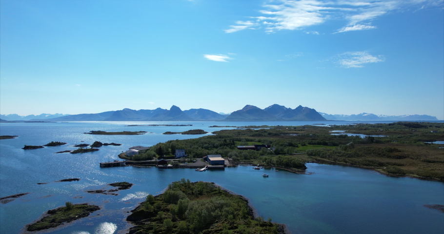 Arial pan shot over idyllic Islands on a nice sunny summer day in Northern Scandinavia, Europe Bo I Vesteralen - Beautiful summer to the sea. Royalty-Free Stock Footage #1087992271