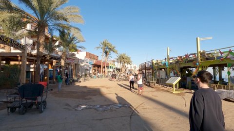 Dahab , Egypt - 02 22 2022: Street view People walking on Dahab coastline city in Egypt, Summer destination