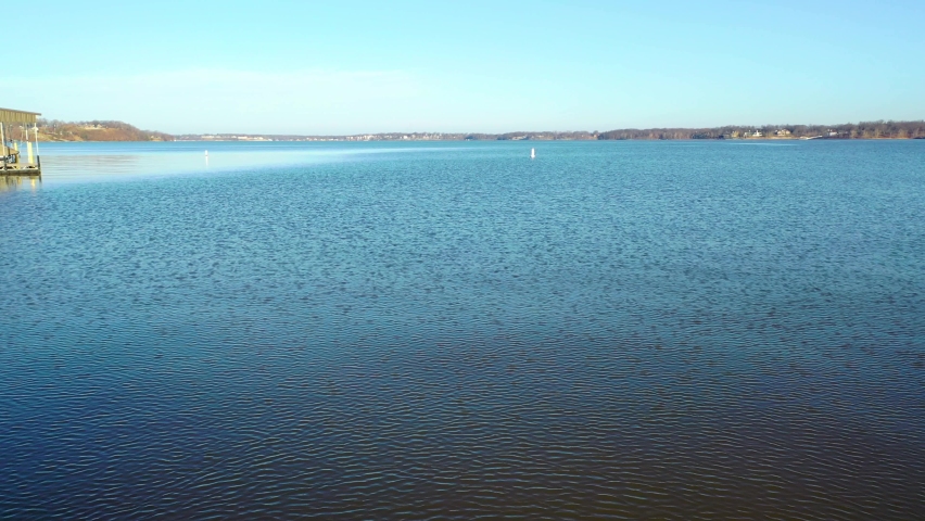 Low Aerial Flying Over Lake Water Towards Buoy Floating. Driving Boat Perspective at Grand Lake O