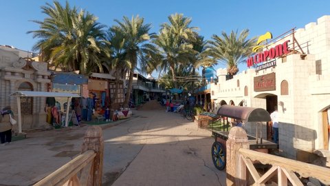 Dahab , Egypt - 02 22 2022: Female walking on Scene, touristic street with restaurants, Travel destination