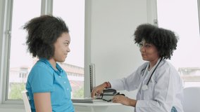 African American doctors counsel young women. Adolescent girls discuss life problems with a psychiatrist. Female doctor giving encouragement to teenagers. mental health concept