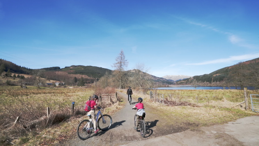 Family on rental bikes ride through Scottish Highlands