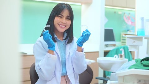 Young female dentist holding Invisalign in dental clinic, teeth check-up and Healthy teeth concept

