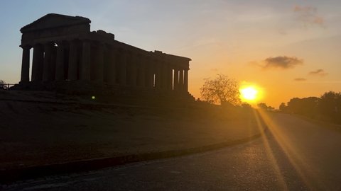 Shooting of the Valley of the Temples in Agrigento in the evening during the almond blossom in February. Temple of Concord, Apollo. Sunset.