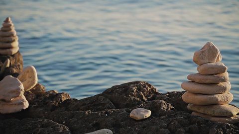 Zen stones on a ocean sea cliff in sunset sunrise time.	
