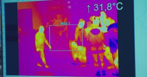 A view of a screen showing video from a thermal imaging camera recording the elevated body temperature of people passing through a store.