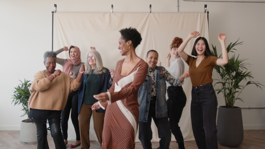 Slow motion dolly in of cheerful multiethnic women smiling and dancing, in celebration of International Women's Day | Shutterstock HD Video #1088004823