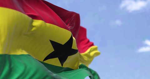 Detail of the national flag of Ghana waving in the wind on a clear day. Ghana is a country in West Africa. Selective focus. Seamless loop in slow motion