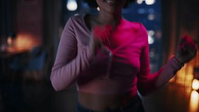 Portrait of Multiethnic Young Latin Female Dancing in Futuristic Neon Glowing Glasses, Having a Party at Home in Loft Apartment. Recording Funny Viral Videos for Social Media. Close Up Handheld Shot.