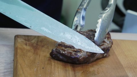 Freshly baked meat steak on a cutting board.