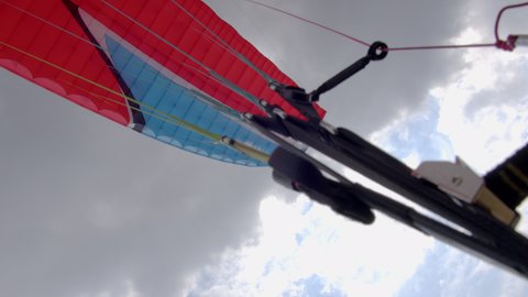 Paragliding. Extreme sport. Detailed shot of a paraglider flying in the sky. 4k