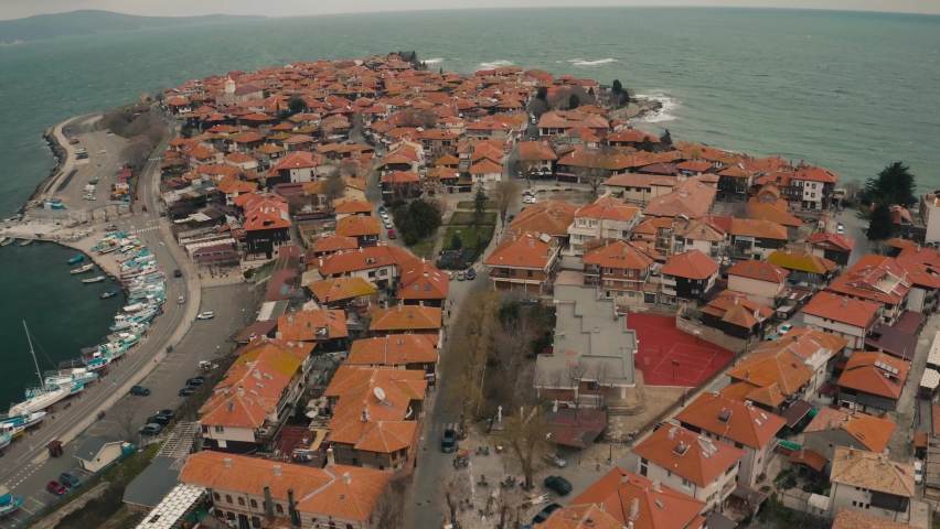 Aerial drone fly over old town Nessebar Bulgaria. Beautiful Landscape view of small town into the sea at winter cloudy contidions.