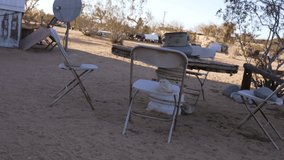 This video features an abandoned and dilapidated patio table setting in a post apocalyptic desert scene.