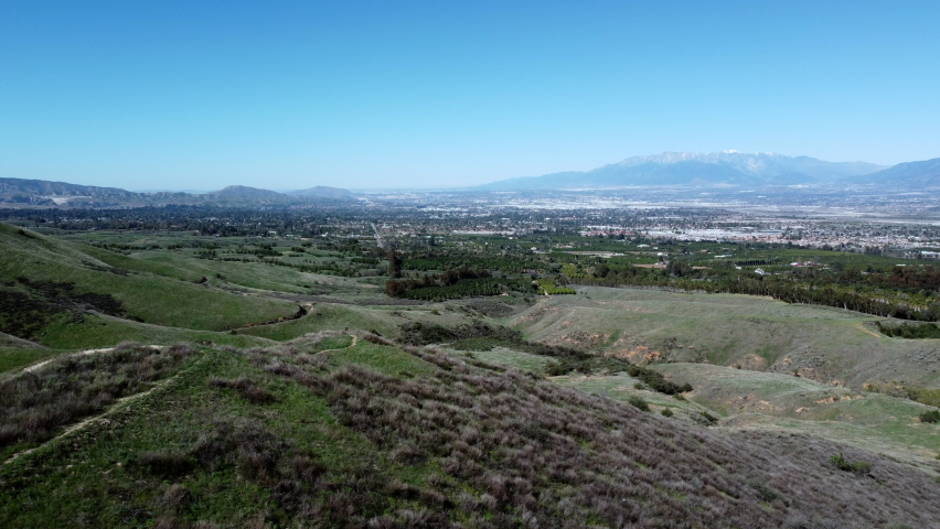 A Mountain Biker Riding Up a Fire Road Trail in Crafton Hills, California, as Seen from a UAV Drone Flying Along Side