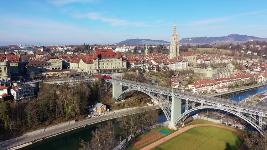 Aerial drone footage of a tram on the Kirchenfeld bridge in Bern historic and city center in Switzerland on a sunny winter day. 