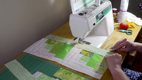Sewing quilt block together on a sewing machine - slow motion log-cabin pattern