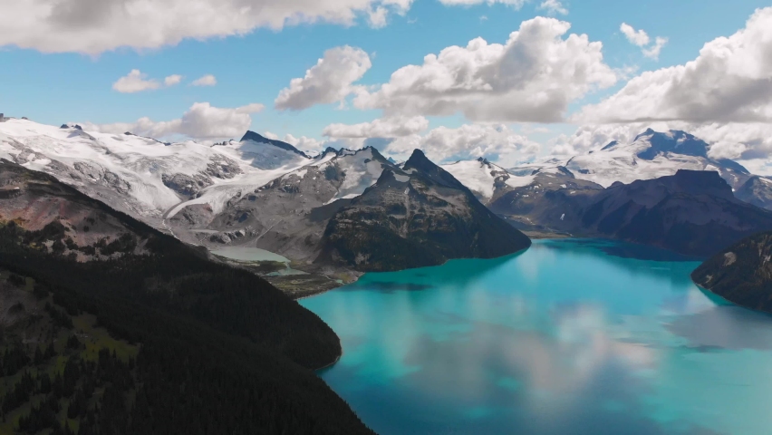 Moving clouds above Garibaldi Lake in Canada, British Columbia, aerial drone view of beautiful nature around