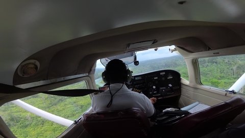 Pilot Landing on remote jungle airstrip in Cessna aircraft.
