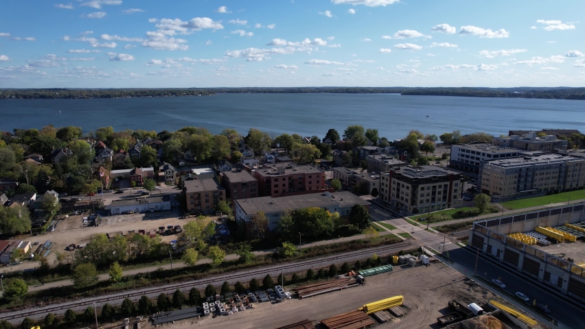 Aerial View of Industrial Railway and Neighborhood of Madison, Wisconsin USA With Lake Monona in Background - Drone Shot