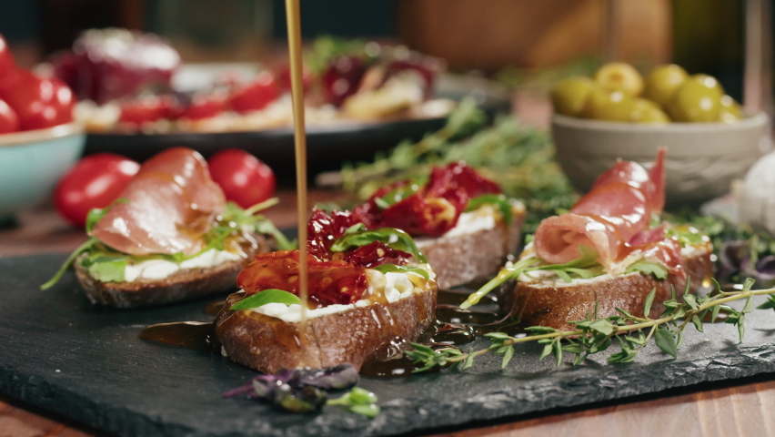 Italian restaurant with traditional food, Spanish cuisine, delicious tapas and white wine, bruschetta with cheese, olives dry tomatoes and tasty sandwich bar appetizer, buffet high cuisine table Royalty-Free Stock Footage #1088022663