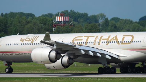 DUSSELDORF, GERMANY - JULY 22, 2017: Airbus A340 Etihad picking up speed before takeoff at Dusseldorf Airport (DUS). Rear view, passenger plane departure. Etihad Airways is the national airline of the