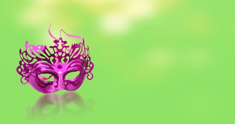 The concept of the Jewish festival of Purim. Carnival mask with bokeh effects on a green background