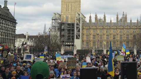 LONDON PARLIAMENT SQUARE, UK - MARCH 06 2022: Anti-War Protesters in London Rally Against Russian Invasion of Ukraine in Front of Big Ben