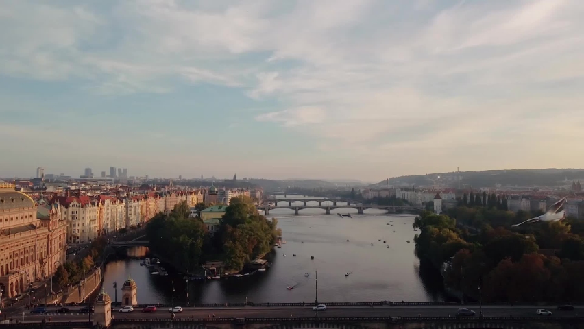Catamarans on Vltava river near the Charles bridge at sunset light. Prague old town. | Shutterstock HD Video #1088028337
