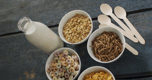 Video of cereals in ceramic bowls on wooden kitchen worktop. breakfast food and cooking ingredients concept.
