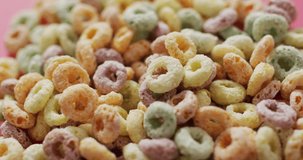 Video of colorful breakfast round cereals on white background. breakfast food and cooking ingredients concept.