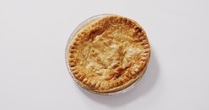 Video of pie seen from above on white background. dessert, food and cooking ingredients concept.