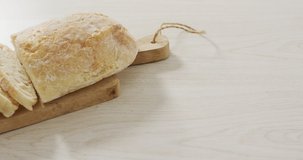 Video of bread on wooden chopping board seeing from above. food and cooking ingredients concept.