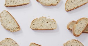 Video of slices of bread seeing from above on white background. food and cooking ingredients concept.