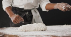 Video of cook throwing flour on the table on black background. food and cooking ingredients concept.
