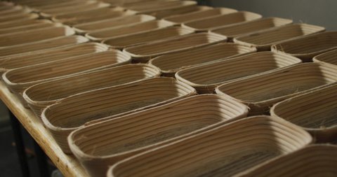 Animation of rows with bred molds preparing for use in bakery. working at bakery, independent small business.