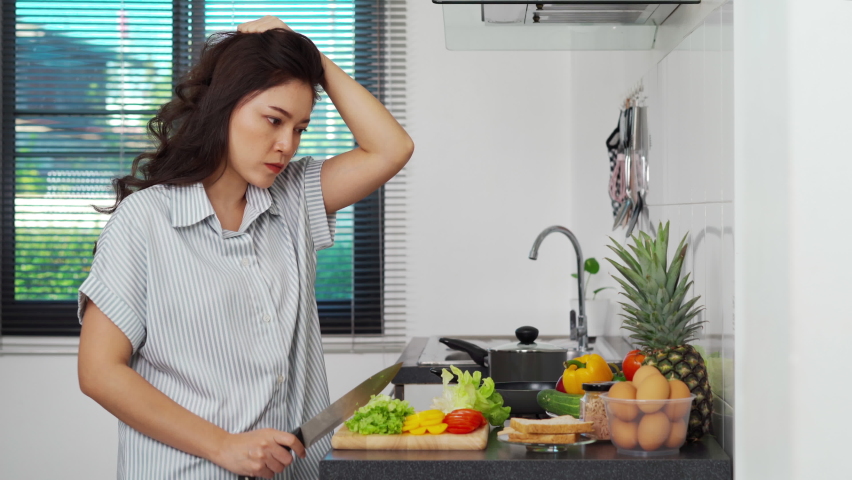 stressed woman with preparing vegetables to cooking in the kitchen at home Royalty-Free Stock Footage #1088032357