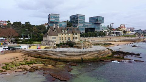 Estoril , Portugal - 03 02 2022: Aerial view in front of the Auditorio Fernando Lopes-Graça, cloudy in Portugal - Ascending, drone shot