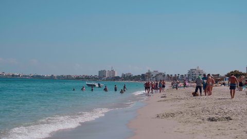Monastir, Tunisia - September 25, 2021: Summertime scene on a beautiful beach with many people. Holiday destination in Tunisia. Mediterranean sea.