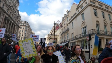 London, UK - 03 06 2022: colorful young pretty girls chant fuck putin London march support ukraine audio
